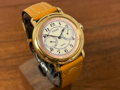 (1988) Pulsar V336-7040 dress watch - gold colored case - creme dial w/ Arabic numerals