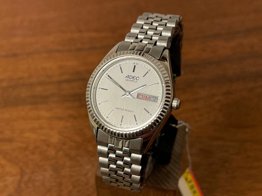 Front side (1980) ADEC (by Citizen) "Day-Date" - fluted bezel - silver dial w/ stick markers - small size (NOS)