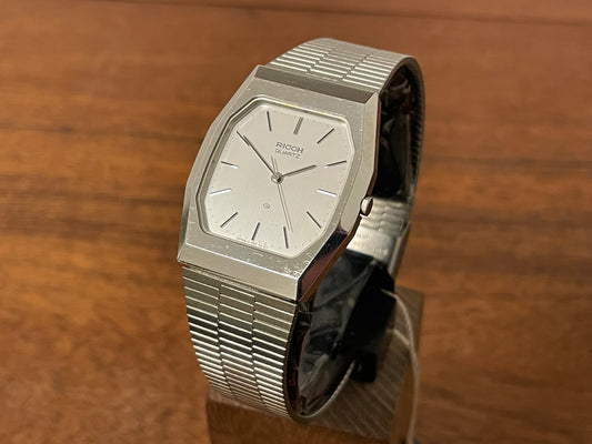 Front side (1977) Ricoh 702008SS dress watch - silver brushed dial w/ silver markers (NOS)