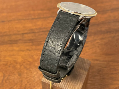 (1980s) Universal Genève 6-566 dress watch - silver case w/ gold beaded bezel - grey sunburst dial (NOS)