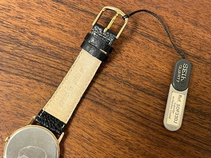 (2000) Seiko 5Y39-7010 dress watch - gold colored case - black dial w/ flat gold Arabic numerals (NOS)