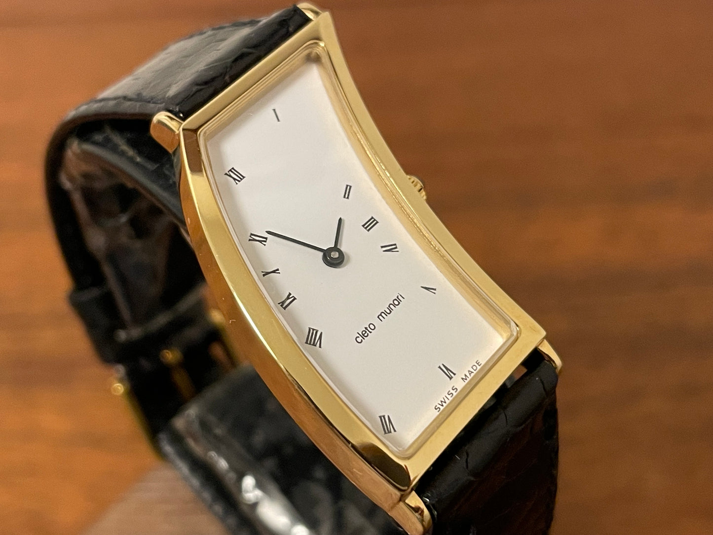 (1988) Cleto Munari "Parentesi" by Hans Hollein - asymmetrical 18K gold electroplated case - white dial w/ Roman numerals  (NOS + full set)