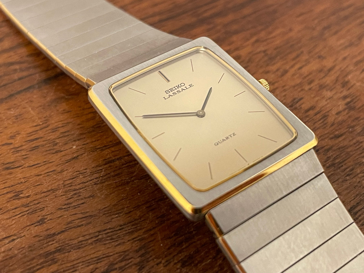 (1983) Seiko 6730-565H Lassale ultra thin - stainless steel bracelet - brushed gold dial w/ black stick markers (NOS)