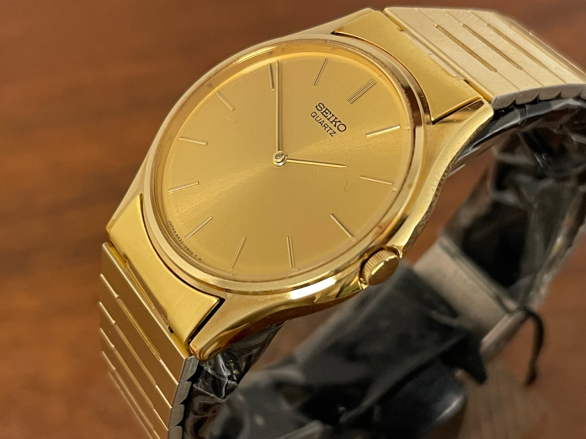 (1983) Seiko 8420-0140 dress watch - gold case - gold sunburst dial w/ gold stick markers (NOS)