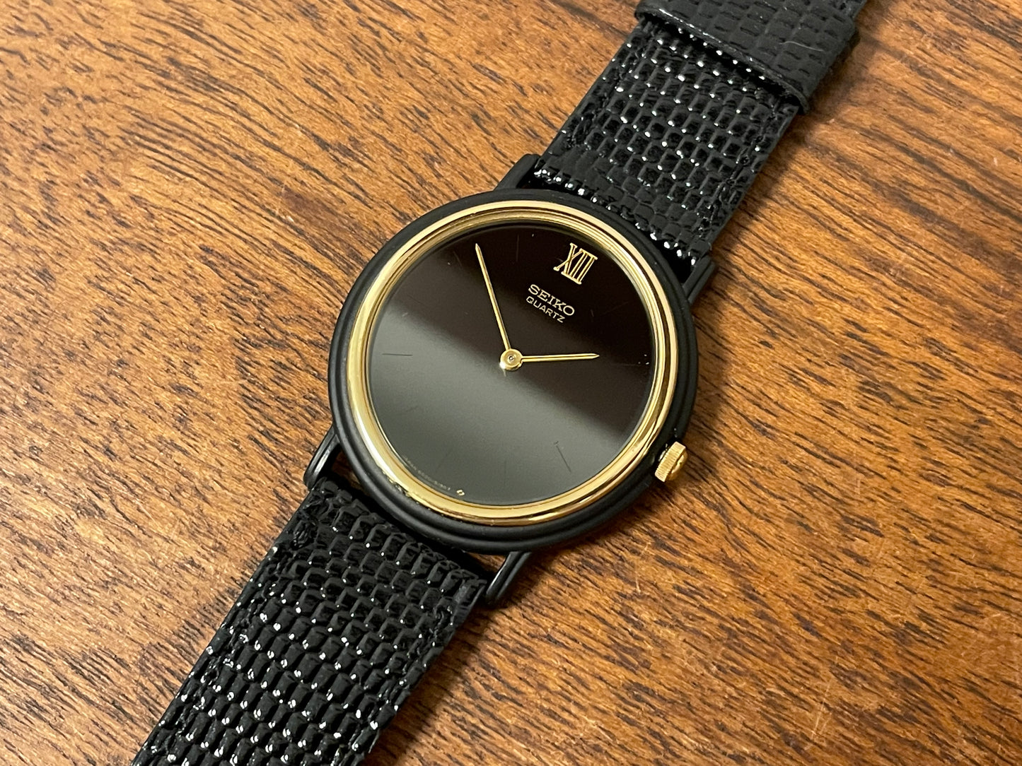 (1993) Seiko 6530-5120 dress watch- oval black case w/ gold bezel en hands (NOS)