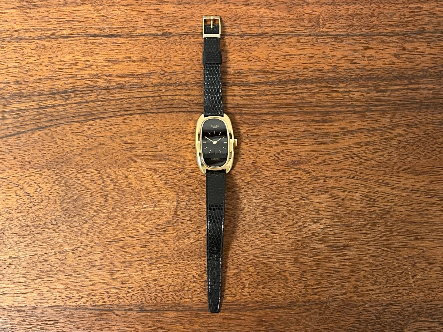 (1979) Timex 100 manual wind dress watch - Swiss made - tonneau case - black dial w/ gold markers