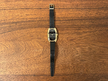 (1979) Timex 100 manual wind dress watch - Swiss made - tonneau case - black dial w/ gold markers