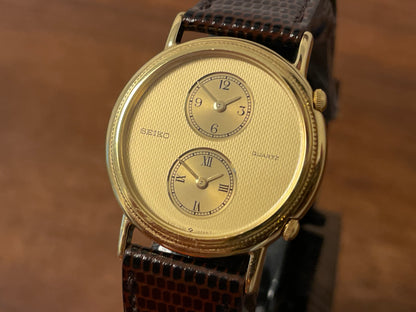 (1985) Seiko 1E20-0160 dual time dress watch - round case - gold textured dial w/ 2 subdials