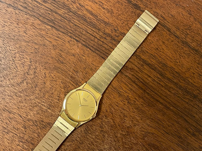 (1983) Seiko 8420-0140 dress watch - gold case - gold sunburst dial w/ gold stick markers (NOS)