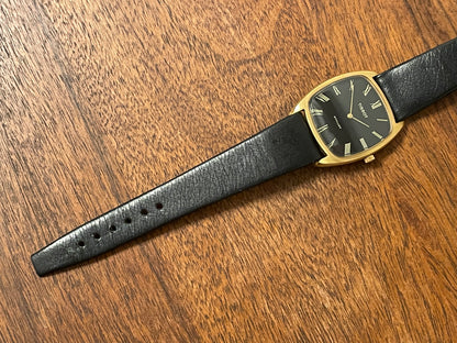 (1970s) Tissot Stylist dress watch - gold case - black dial w/ gold Roman numerals (NOS)