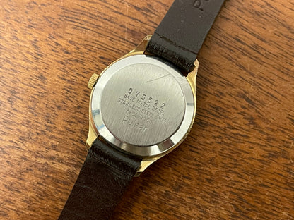 (1990) Pulsar Y480-0060 dress watch - gold colored case - champagne dial w/ black Arabic numerals - small size (NOS)