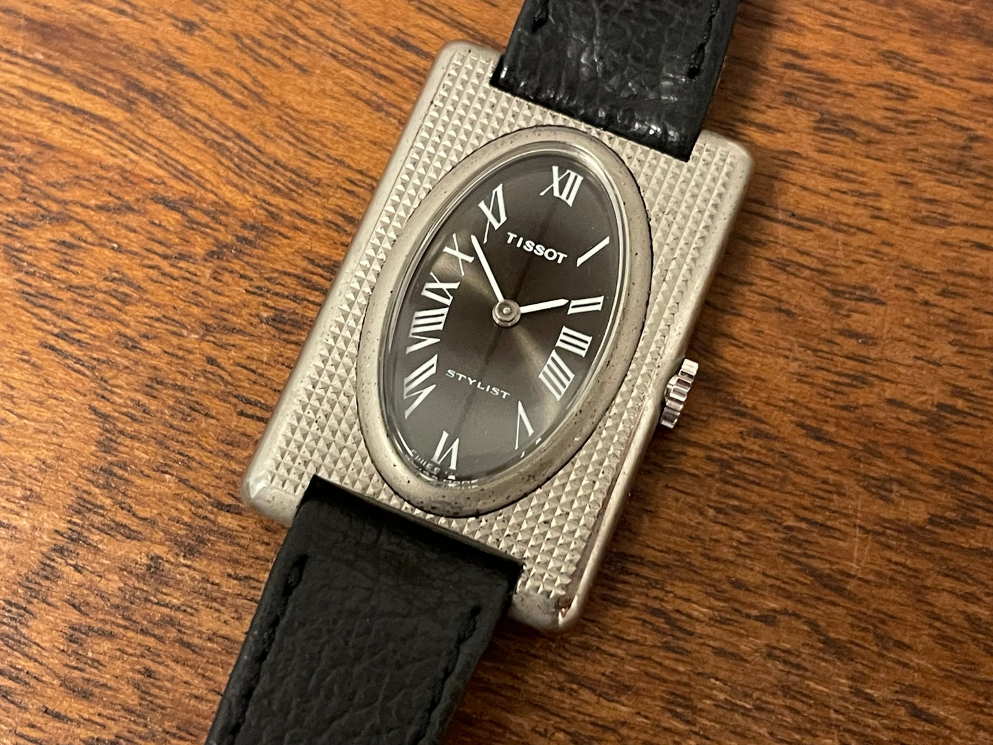 (1970s) Tissot Stylist "Tank" - decorated case - black sunburst dial w/ white Roman numerals - small size (NOS)