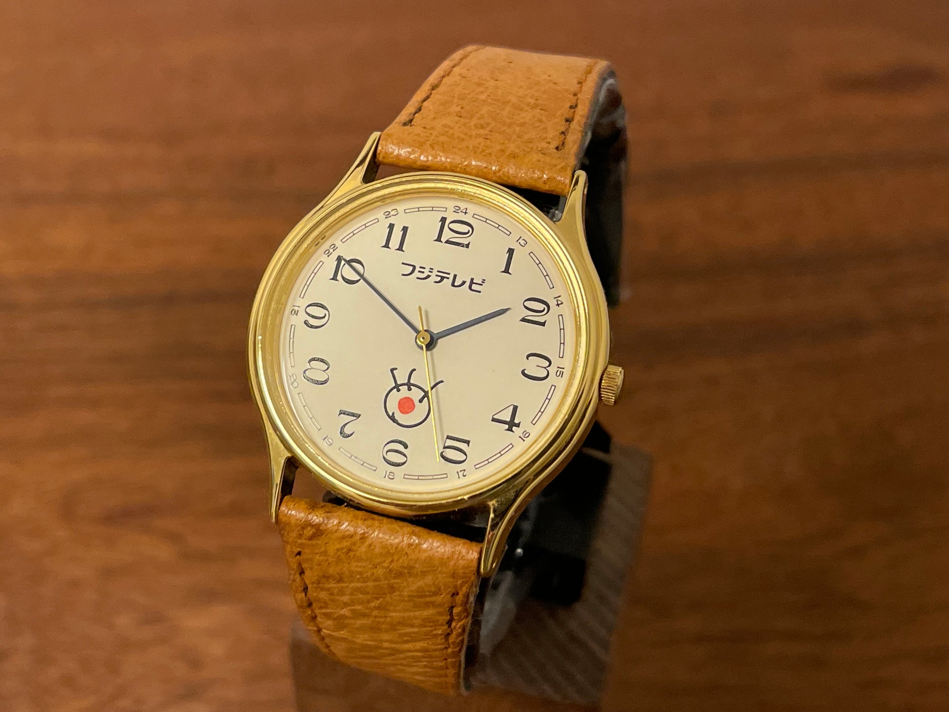 front side (1980s-1990s) Citizen "Fuji Television" logo dress watch - creme dial w/ black Arabic numerals