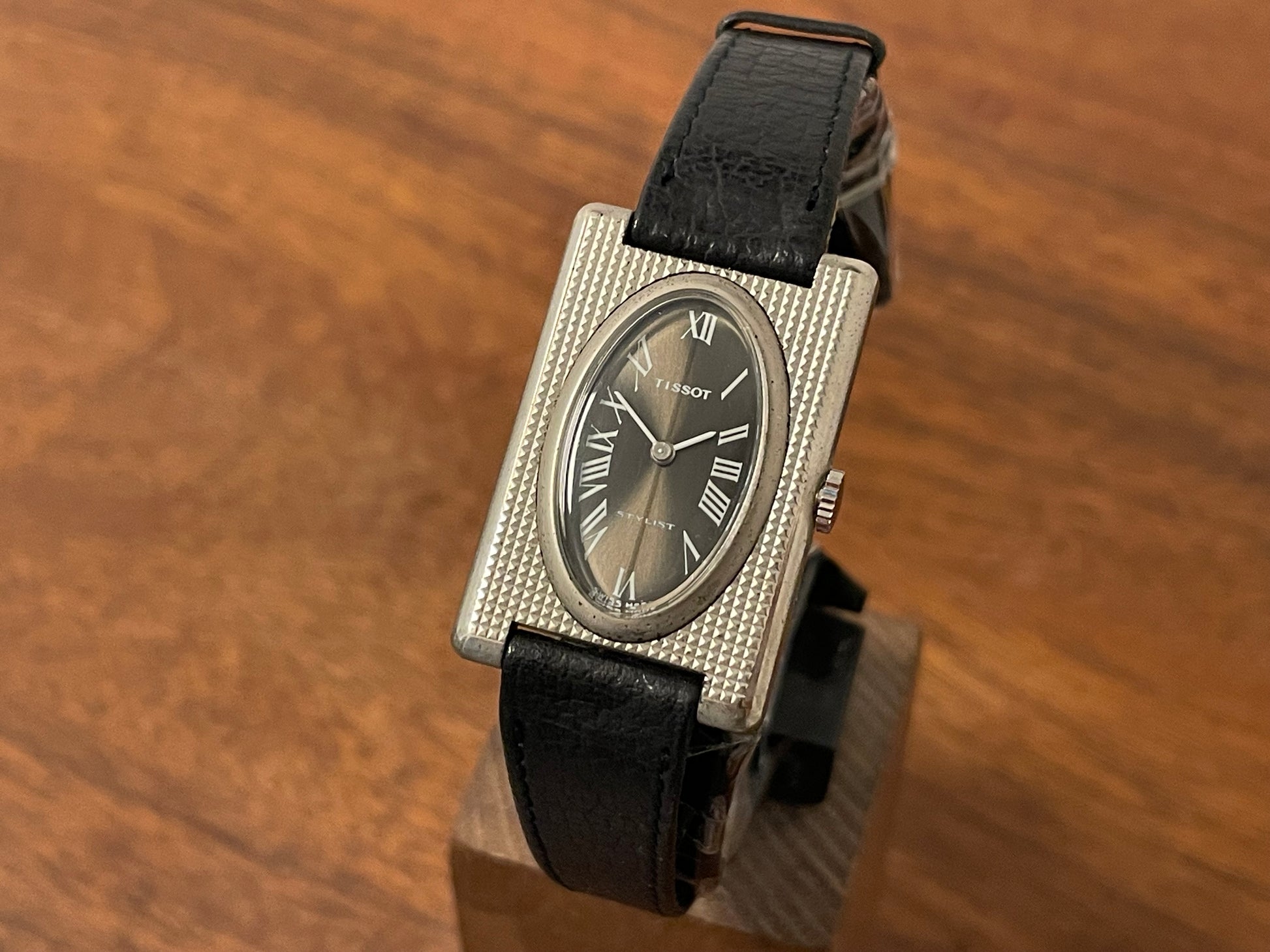 Front side (1970s) Tissot Stylist "Tank" - decorated case - black sunburst dial w/ Roman numerals - small size (NOS)