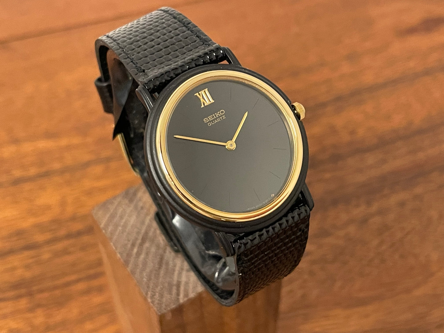 (1993) Seiko 6530-5120 dress watch- oval black case w/ gold bezel en hands (NOS)