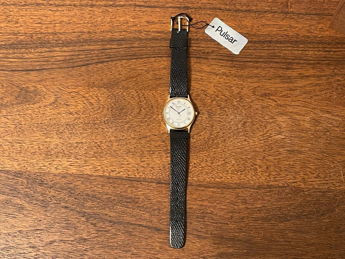 (1990) Pulsar Y552-8009 dress watch - gold colored case - white dial w/ black Roman numerals (NOS)