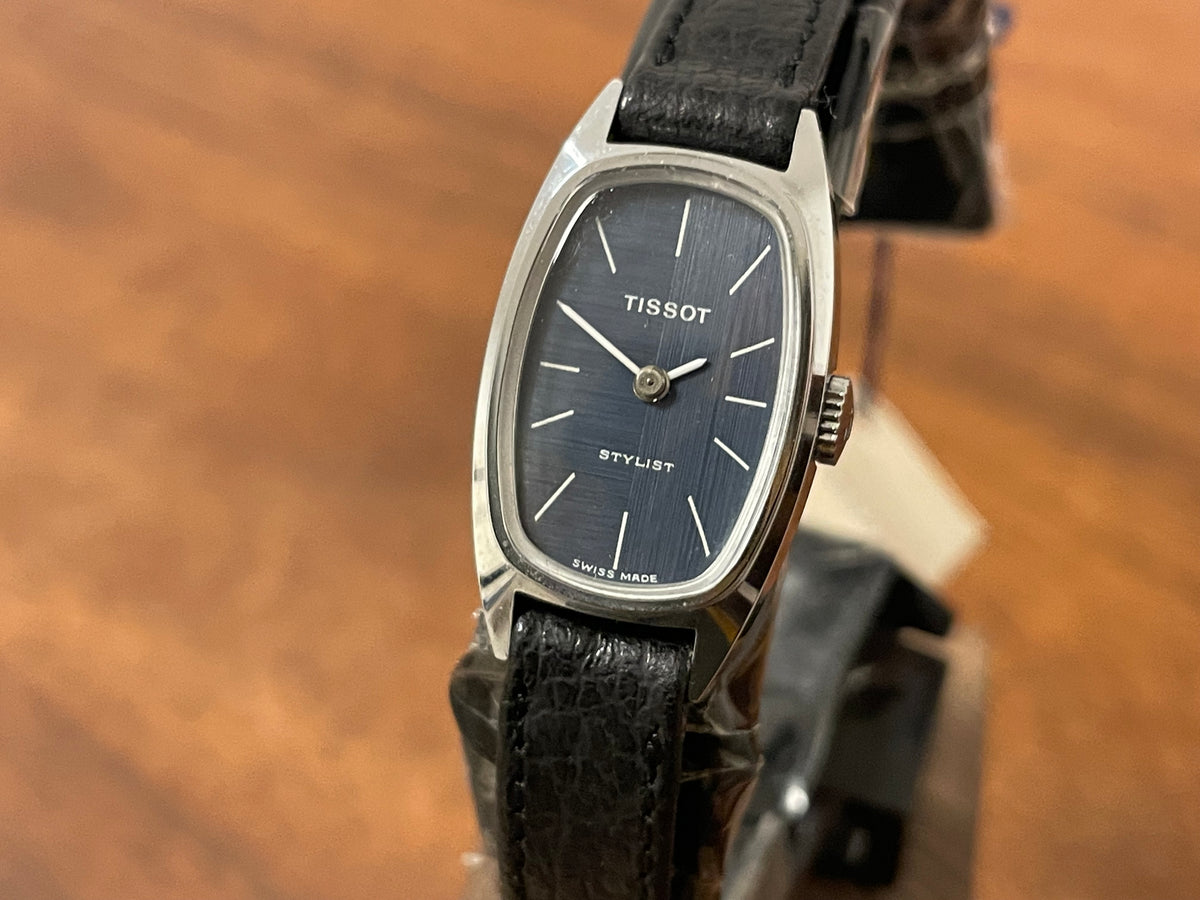 (1970s) Tissot HZ-10720 Stylist dress watch - silver tonneau case - blue brushed dial w/ silver stick markers - small size (NOS)