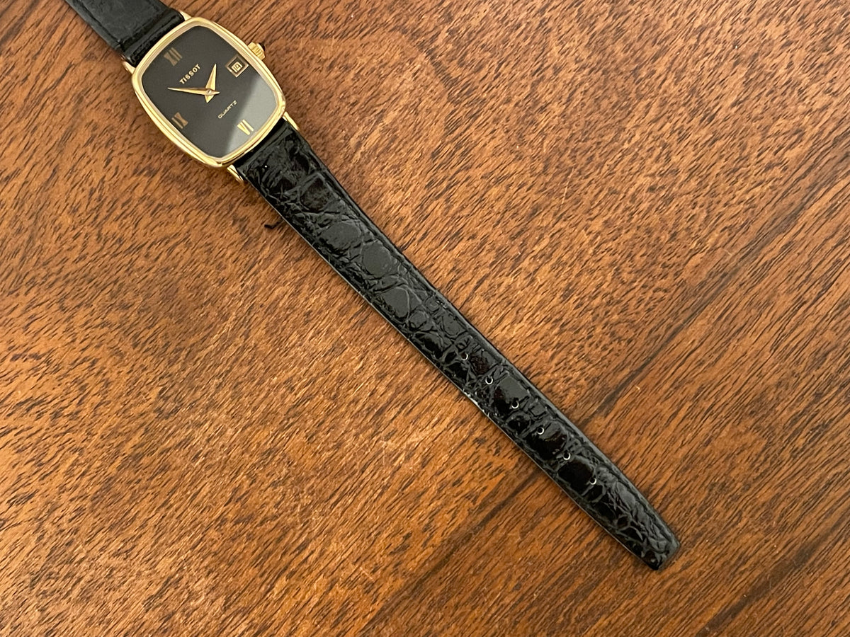 (1980s) Tissot 642.33500/5 Stylist "Ellipse" dress watch - gold case - black dial w/ Roman numerals - small size (NOS)