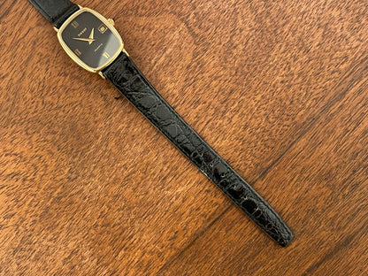 (1980s) Tissot 642.33500/5 Stylist "Ellipse" dress watch - gold case - black dial w/ Roman numerals - small size (NOS)