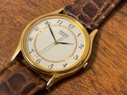 (2003) Seiko 7N01-7041 quartz dress watch - gold case w/ white dial & Arabic numerals (NOS)