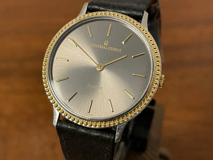 (1980s) Universal Genève 6-566 dress watch - silver case w/ gold beaded bezel - grey sunburst dial (NOS)