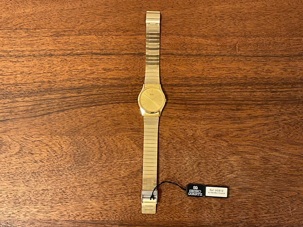 (1983) Seiko 8420-0140 dress watch - gold case - gold sunburst dial w/ gold stick markers (NOS)
