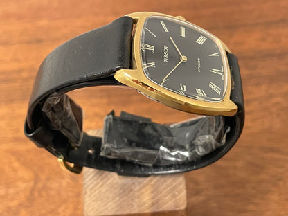 (1970s) Tissot Stylist dress watch - gold case - black dial w/ gold Roman numerals (NOS)