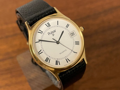 (1990) Pulsar Y552-8009 dress watch - gold colored case - white dial w/ black Roman numerals (NOS)