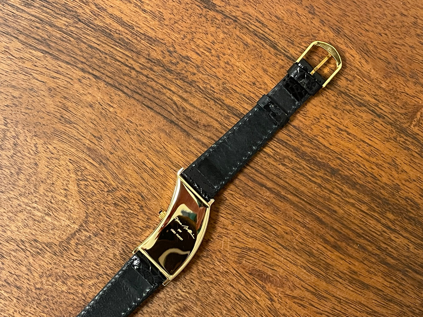 (1988) Cleto Munari "Parentesi" by Hans Hollein - asymmetrical 18K gold electroplated case - white dial w/ Roman numerals  (NOS + full set)