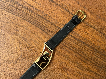 (1988) Cleto Munari "Parentesi" by Hans Hollein - asymmetrical 18K gold electroplated case - white dial w/ Roman numerals  (NOS + full set)