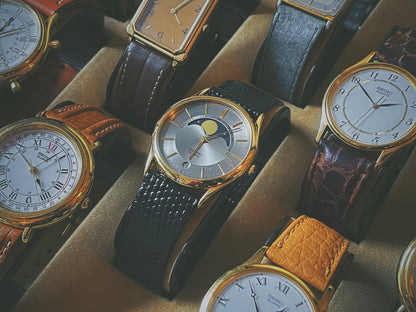 Seiko 7434-7000 dress watch with moon phase in showcase next to other Seiko dress watches