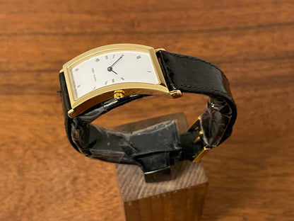(1988) Cleto Munari "Parentesi" by Hans Hollein - asymmetrical 18K gold electroplated case - white dial w/ Roman numerals  (NOS + full set)