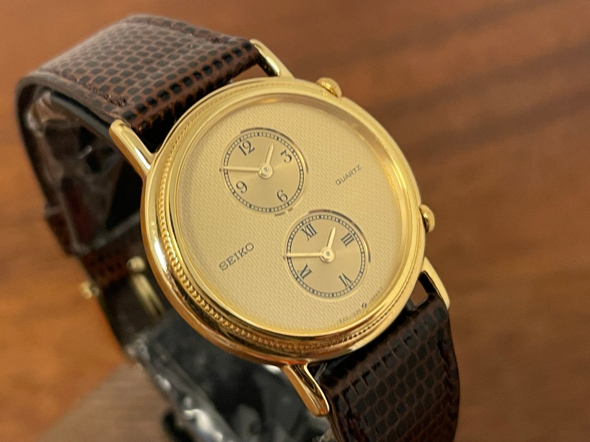 (1985) Seiko 1E20-0160 dual time dress watch - round case - gold textured dial w/ 2 subdials