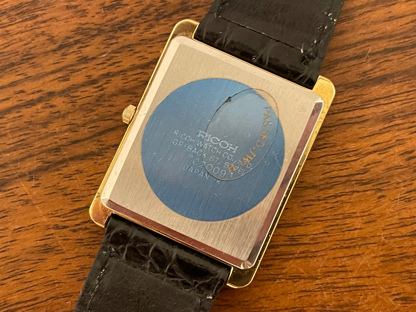 (1977) Ricoh 702009 quartz "Tank" dress watch - black dial w/ gold markers (NOS)