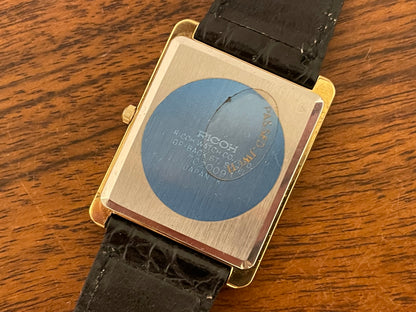 (1977) Ricoh 702009 quartz "Tank" dress watch - black dial w/ gold markers (NOS)