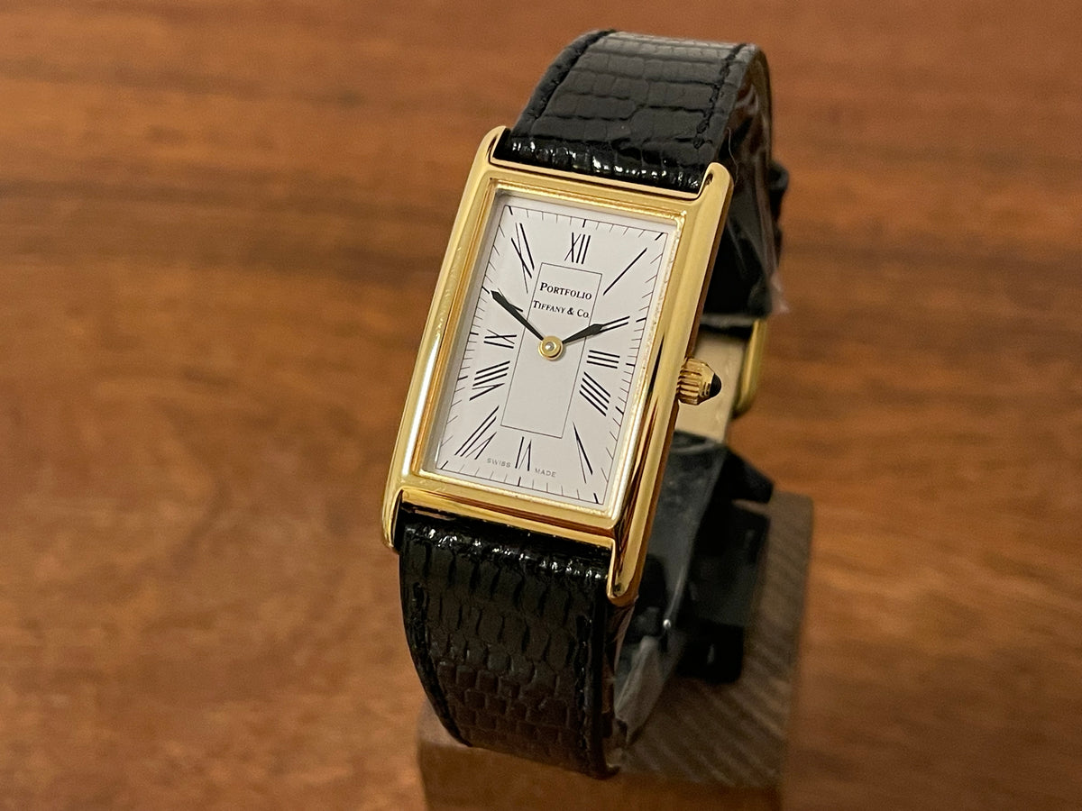 Front side (1998) Tiffany & Co. Portfolio "Tank" dress watch - gold case - white dial w/ black Roman numerals (Mint)