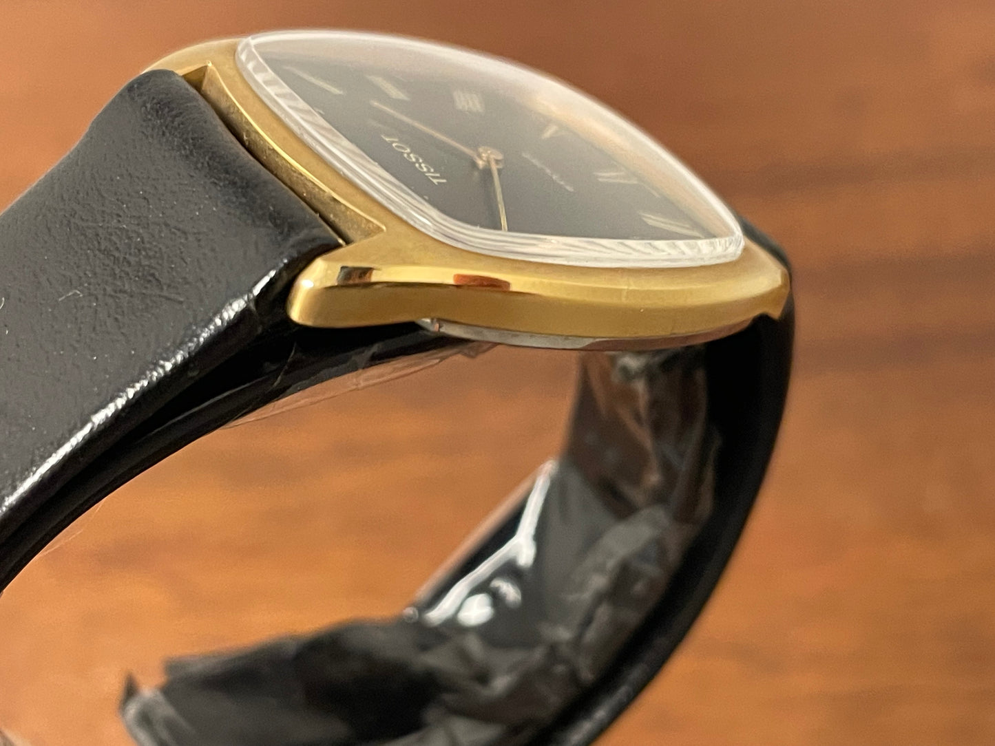 (1970s) Tissot Stylist dress watch - gold case - black dial w/ gold Roman numerals (NOS)