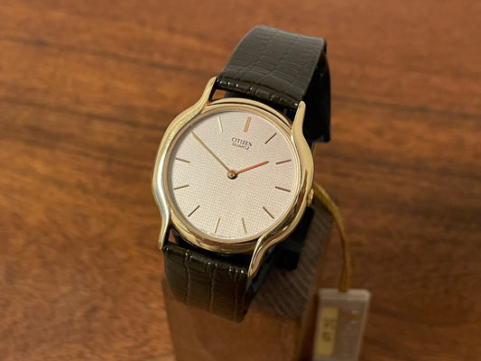 Front side (1976) Citizen 6020-4-Y50335 dress watch - gold colored case - silver textured dial w/ gold markers (NOS)