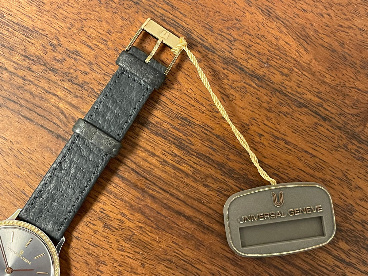 (1980s) Universal Genève 6-566 dress watch - silver case w/ gold beaded bezel - grey sunburst dial (NOS)