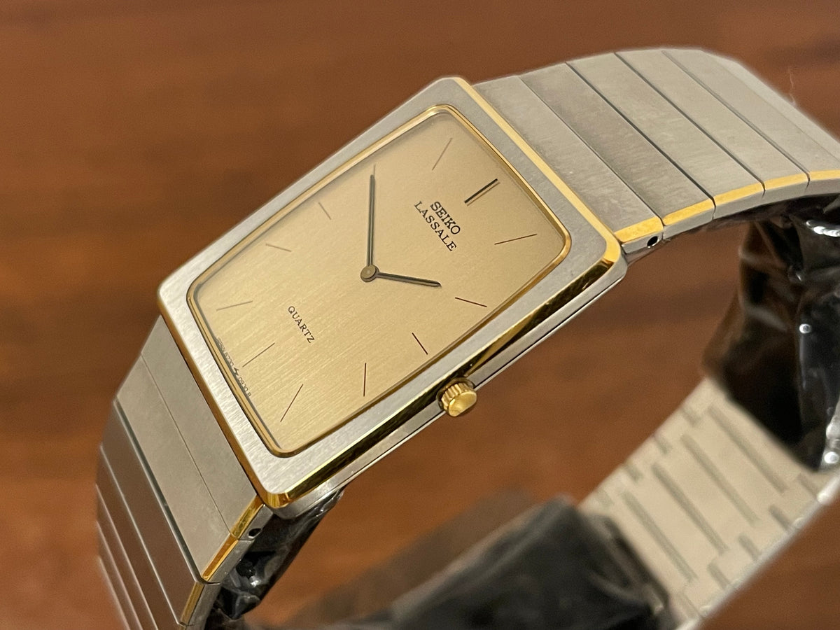 (1983) Seiko 6730-565H Lassale ultra thin - stainless steel bracelet - brushed gold dial w/ black stick markers (NOS)
