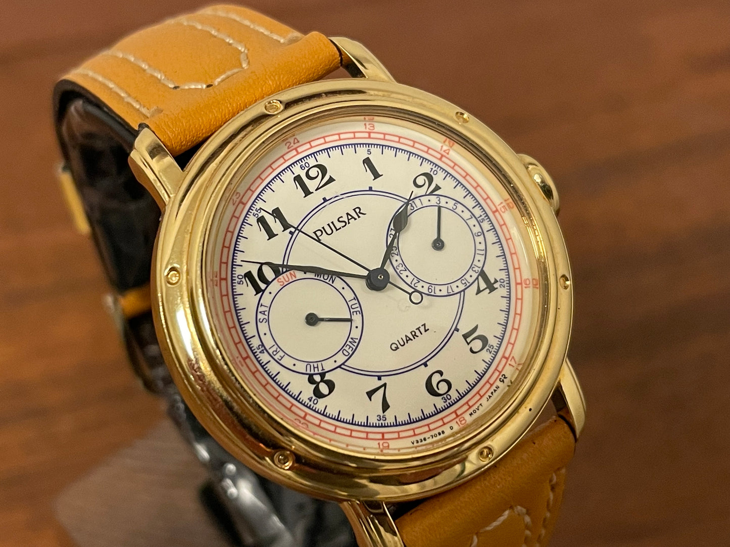 (1988) Pulsar V336-7040 dress watch - gold colored case - creme dial w/ Arabic numerals