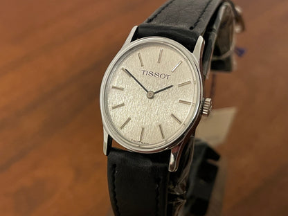 (1970s) Tissot 052-10991 Stylist dress watch - silver oval case - silverdust dial w/ silver stick markers - small size (NOS)