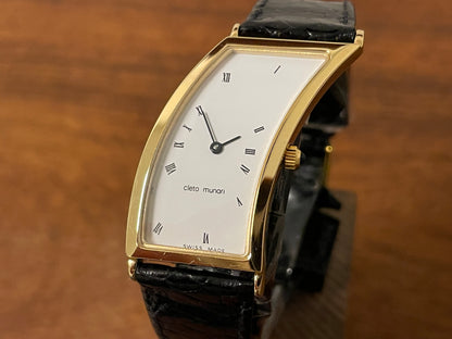 (1988) Cleto Munari "Parentesi" by Hans Hollein - asymmetrical 18K gold electroplated case - white dial w/ Roman numerals  (NOS + full set)