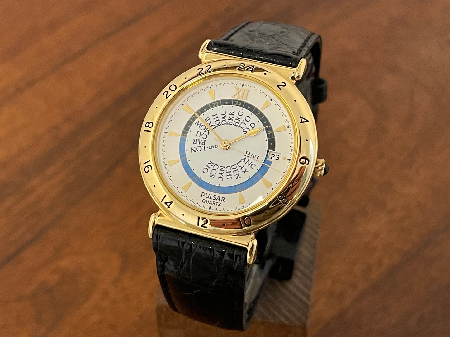 Front side (1999) Pulsar V339-6000 world Timer - gold case - rotating white dial w/ gold markers (NOS)