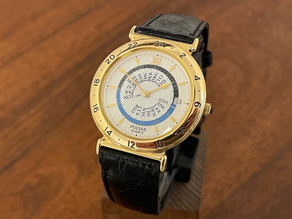 Front side (1999) Pulsar V339-6000 world Timer - gold case - rotating white dial w/ gold markers (NOS)