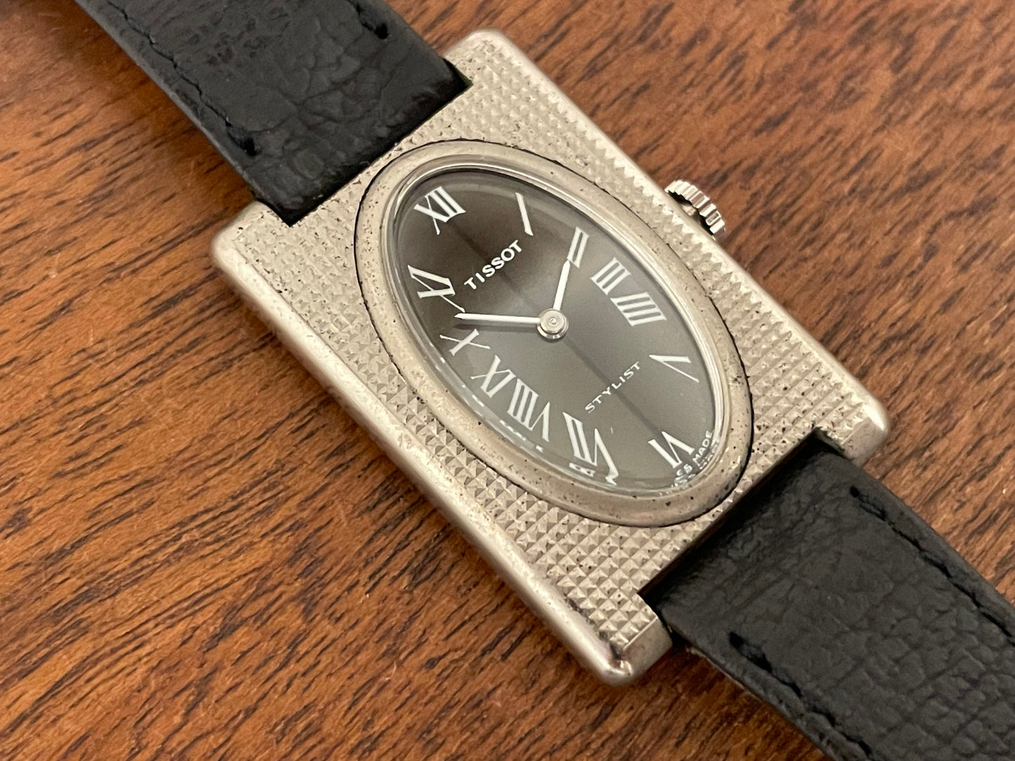 (1970s) Tissot Stylist "Tank" - decorated case - black sunburst dial w/ white Roman numerals - small size (NOS)