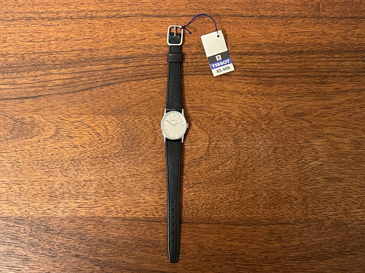 (1970s) Tissot 052-10991 Stylist dress watch - silver oval case - silverdust dial w/ silver stick markers - small size (NOS)