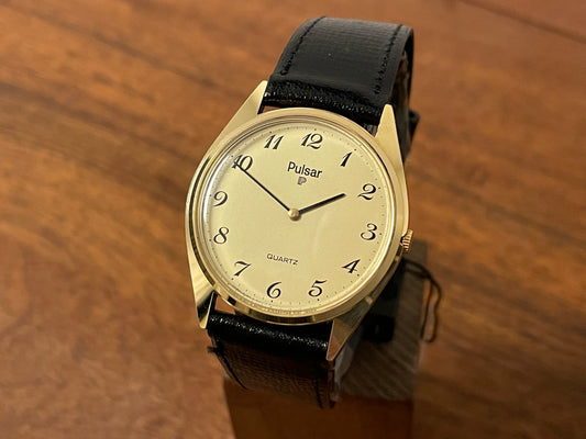 Front side (1991) Pulsar Y480-0460 dress watch - gold colored case - matt champagne dial w/ black Arabic numerals - (NOS)