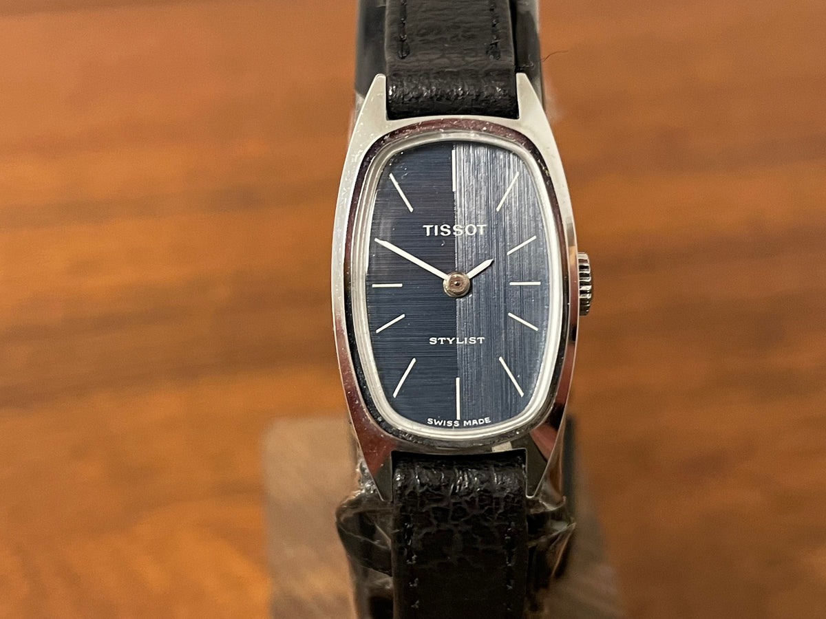 (1970s) Tissot HZ-10720 Stylist dress watch - silver tonneau case - blue brushed dial w/ silver stick markers - small size (NOS)