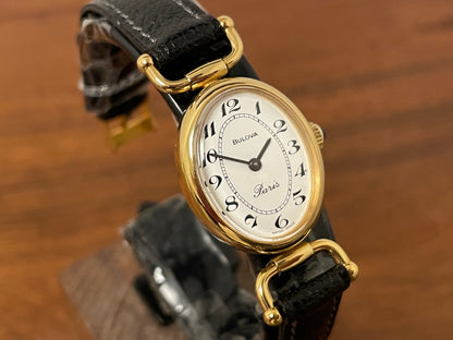 (1980s/1990s) Bulova Paris dress watch - oval case - cream dial w/ black Arabic numerals - small size (NOS)